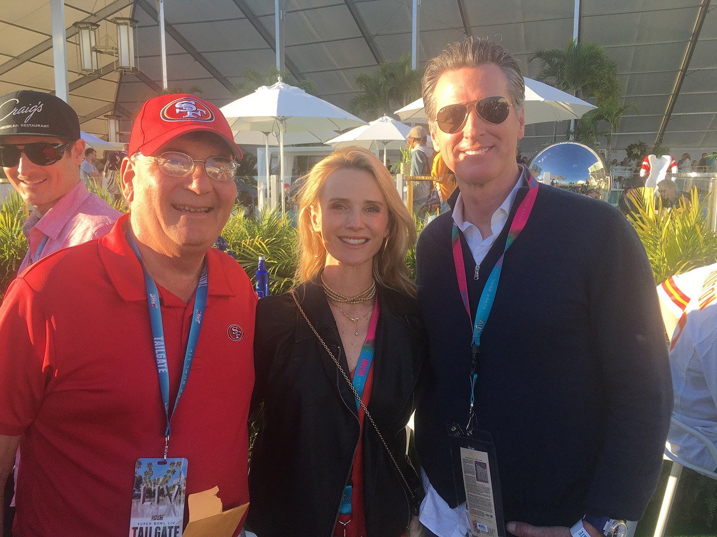 Dr. Tim Baker from The Gualco Group, Inc. visits with fellow 49er fans before the Super Bowl in Miami.
